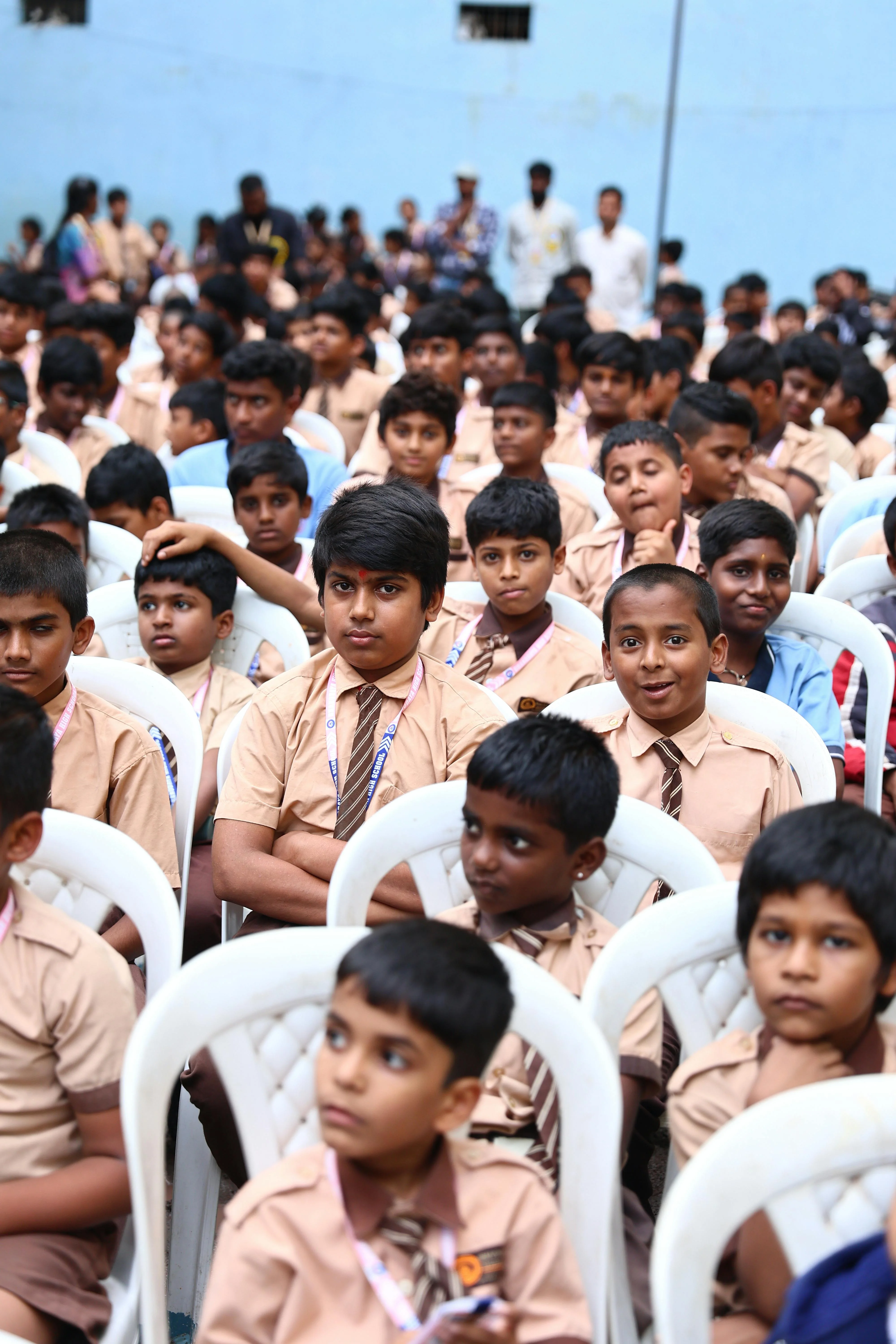 Uniformed students of Satyamev Jayate Gurukulam attentively participating in a school assembly.